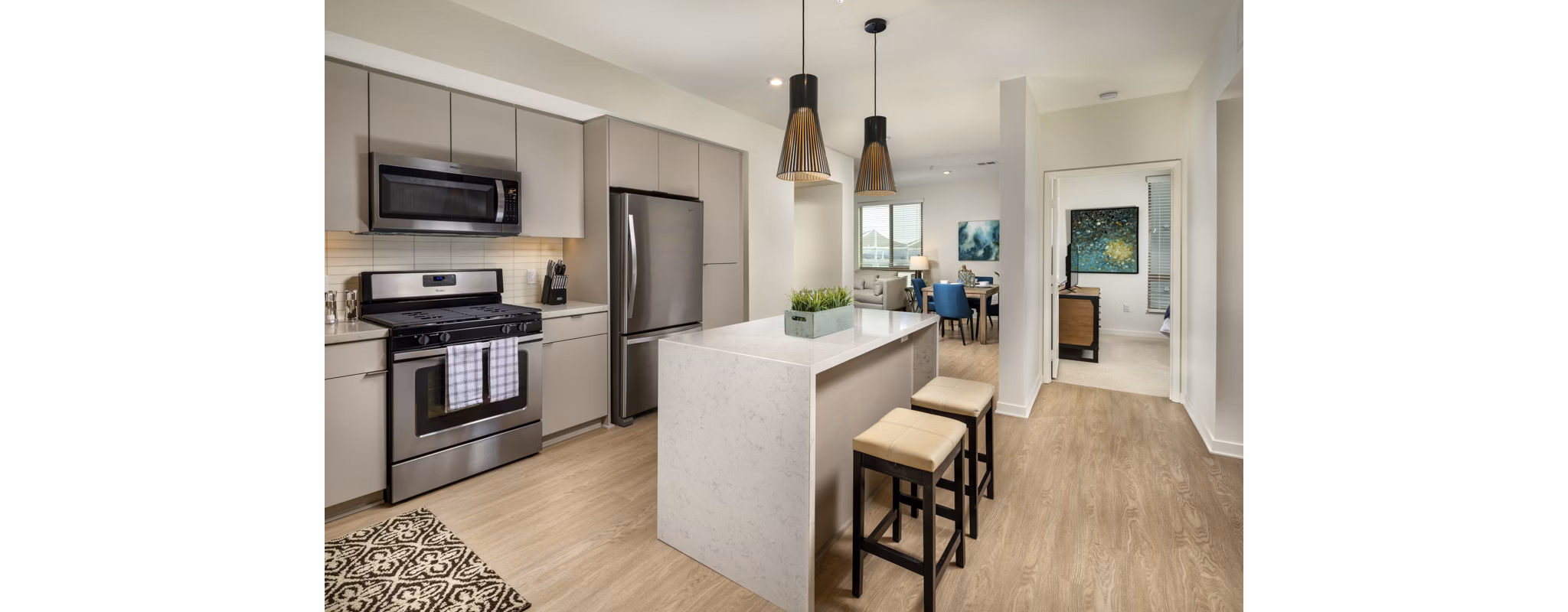 Modern kitchen with stainless-steel appliances at One Paseo Living Apartments
