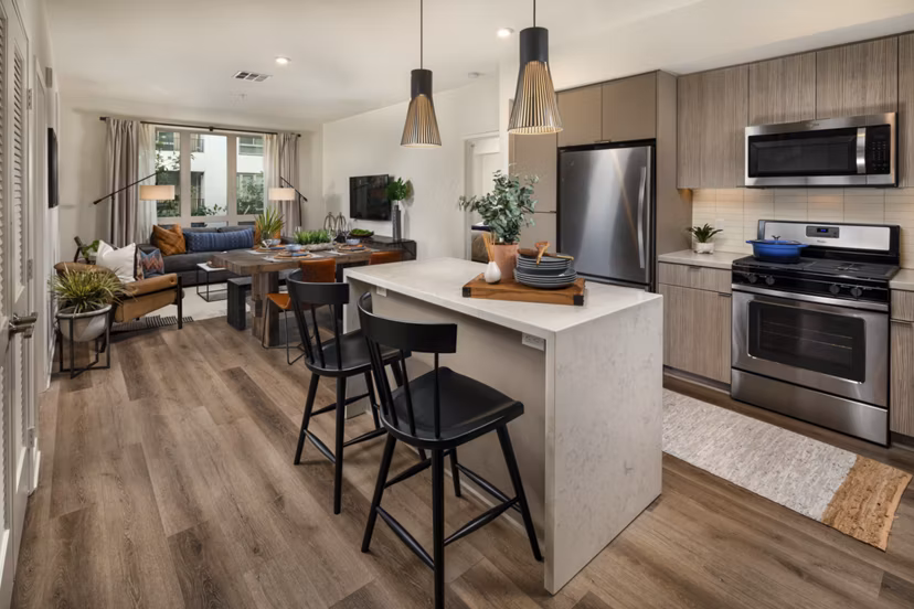 Modern kitchen featuring sleek countertops and stainless steel appliances at One Paseo Living Apartments