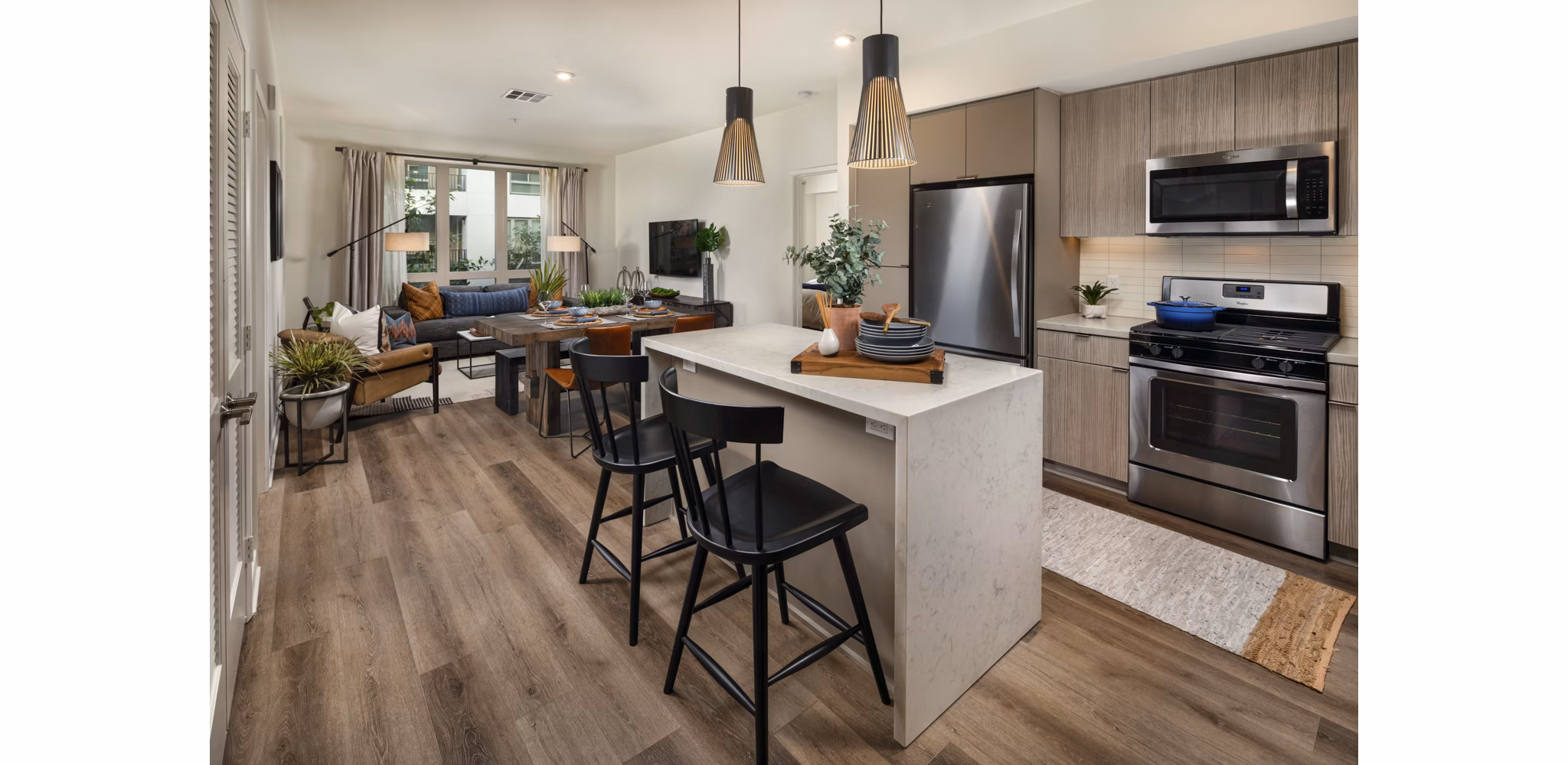 Modern kitchen featuring sleek countertops and stainless steel appliances at One Paseo Living Apartments
