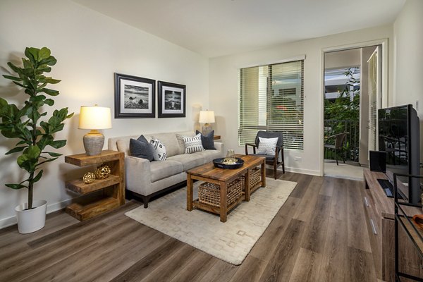 One Paseo Living Apartments: Modern living room with stylish decor and large windows in luxury setting
