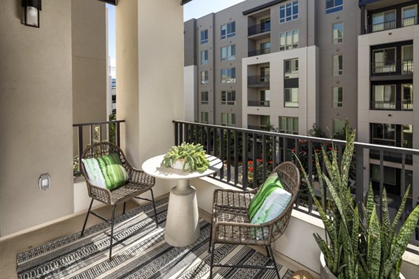One Paseo Living Apartments: Spacious patio with modern seating in luxury complex