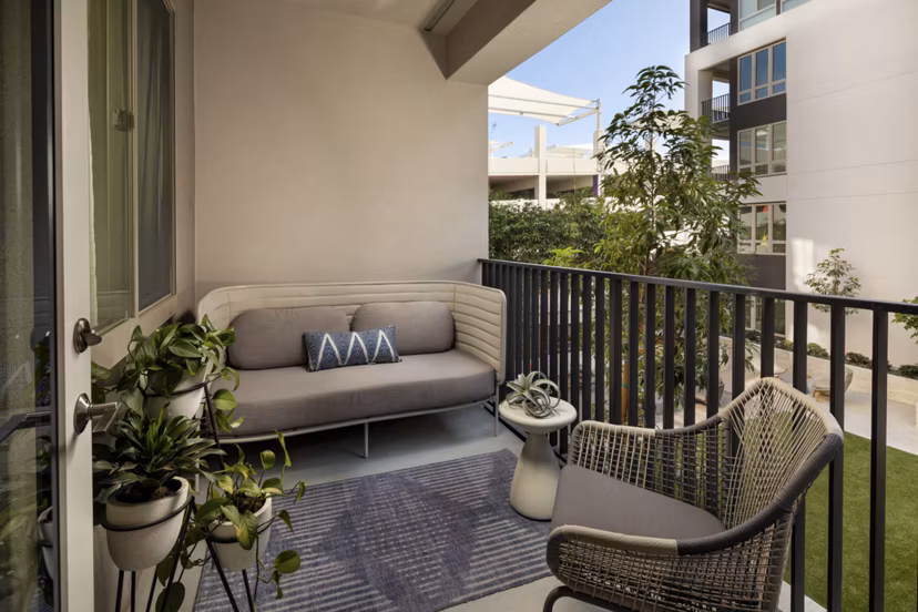 One Paseo Living: Stylish patio area with outdoor seating at luxury apartments in San Diego