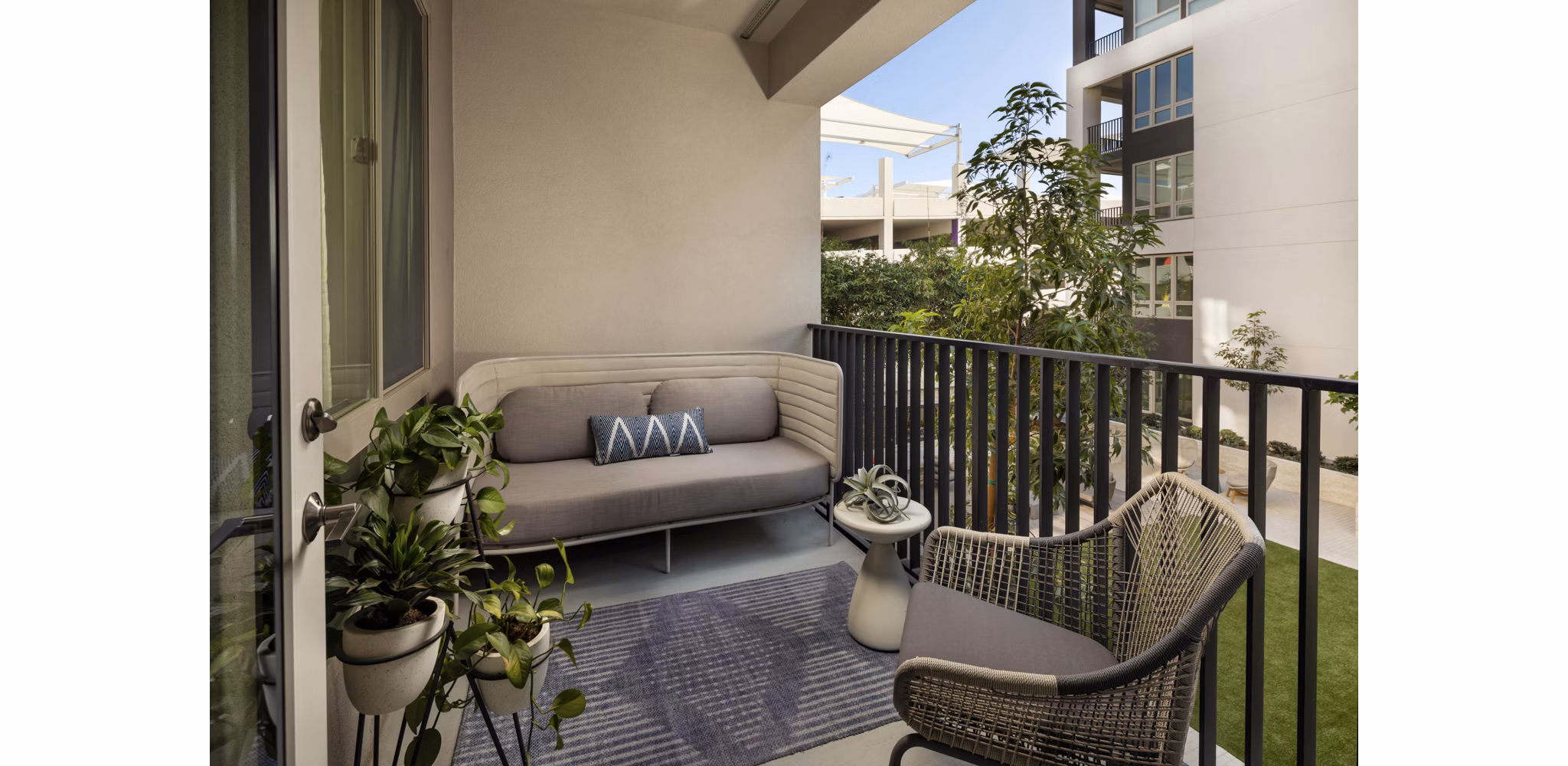 One Paseo Living: Stylish patio area with outdoor seating at luxury apartments in San Diego