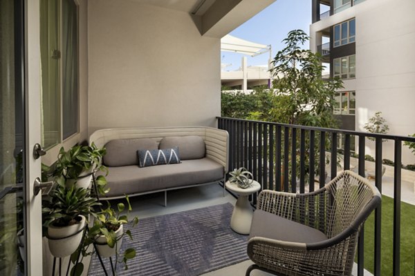 One Paseo Living: Stylish patio area with outdoor seating at luxury apartments in San Diego