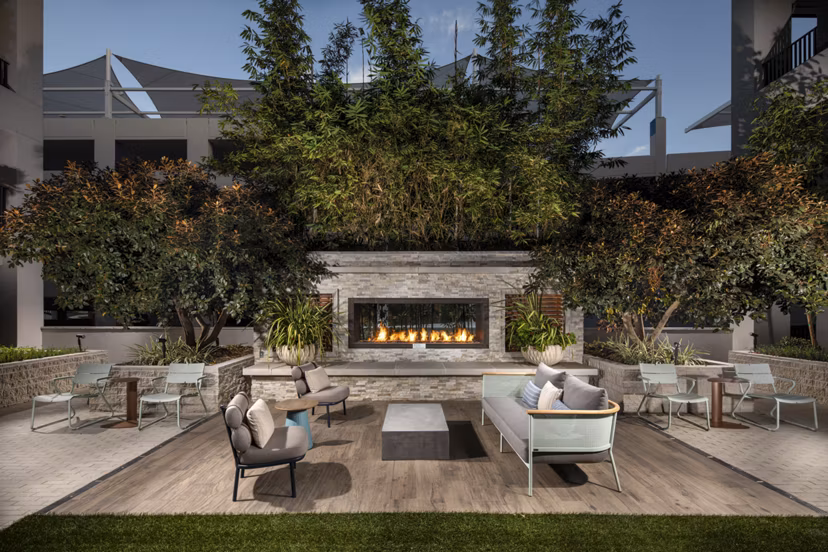 Cozy fire pit lounge area at One Paseo Living Apartments