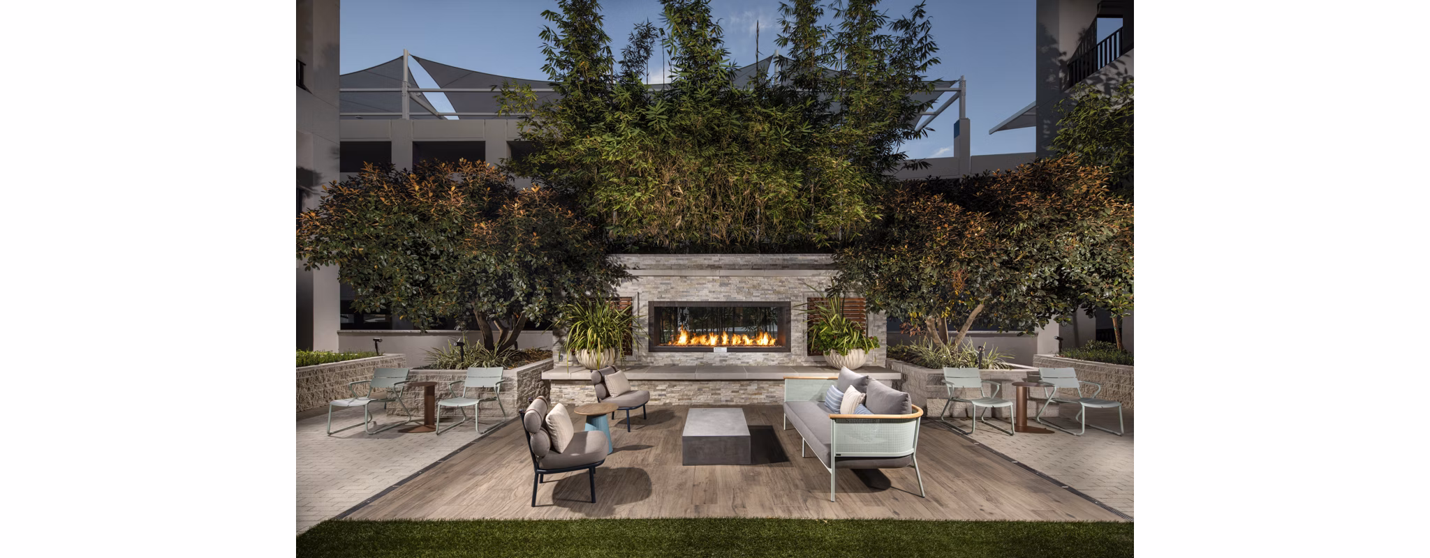 Cozy fire pit lounge area at One Paseo Living Apartments