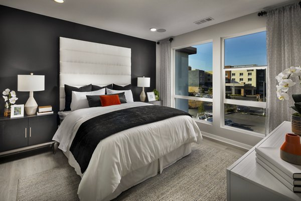 Cozy bedroom with designer furnishings at Anden luxury apartments