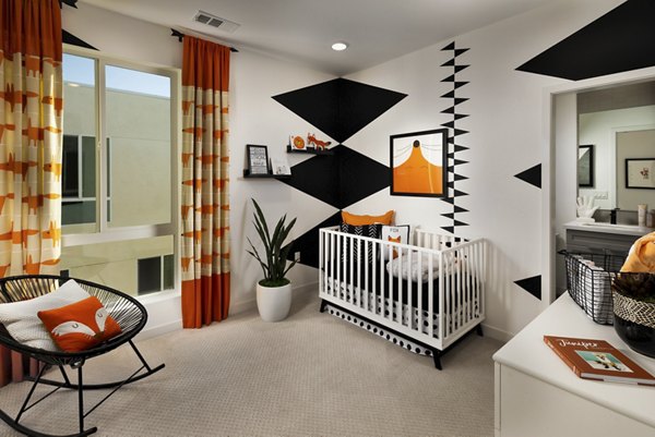 Cozy bedroom with contemporary decor at Anden luxury apartments, featuring a plush bed and stylish accents