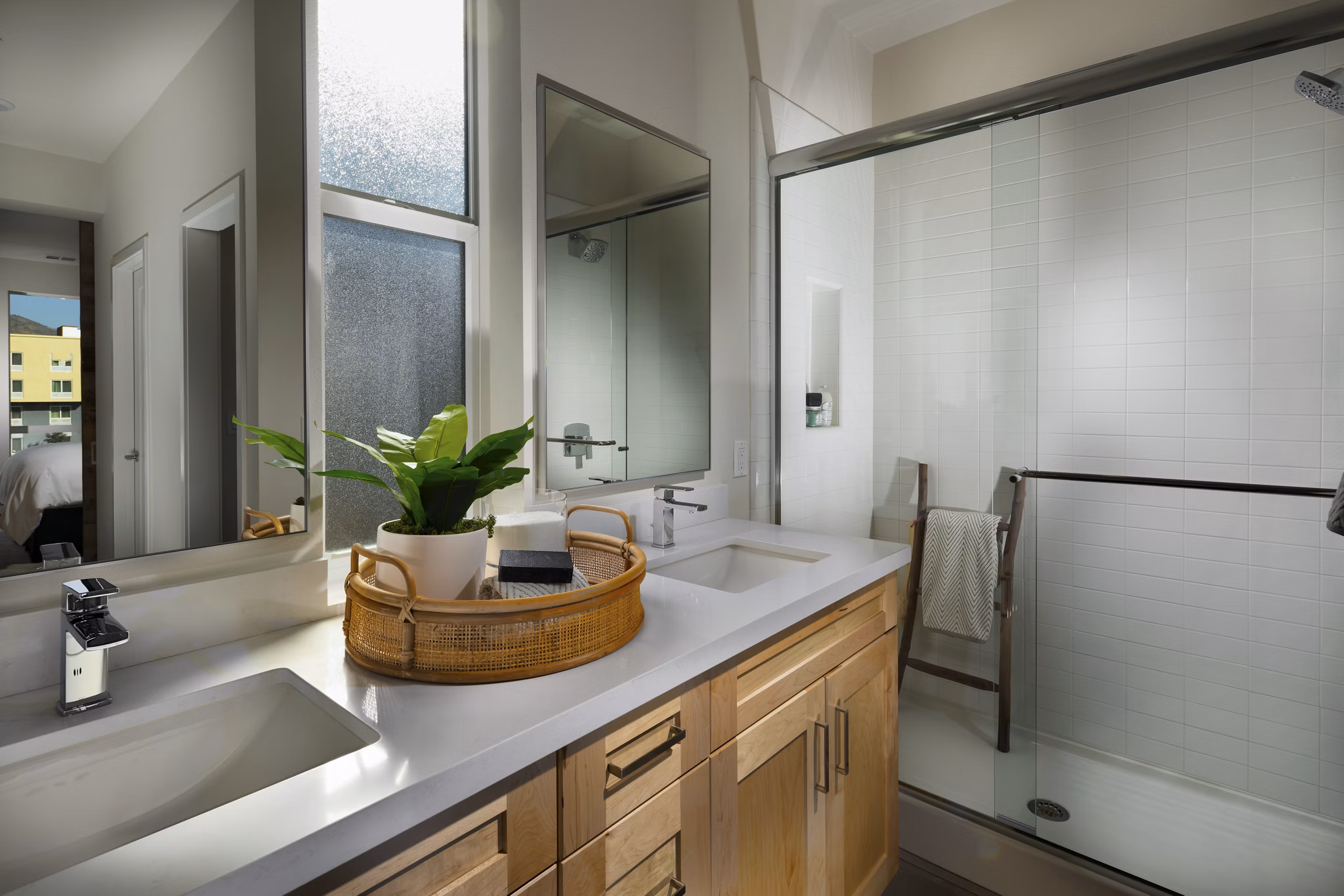 Modern bathroom with sleek countertops and large mirror in Anden luxury apartments