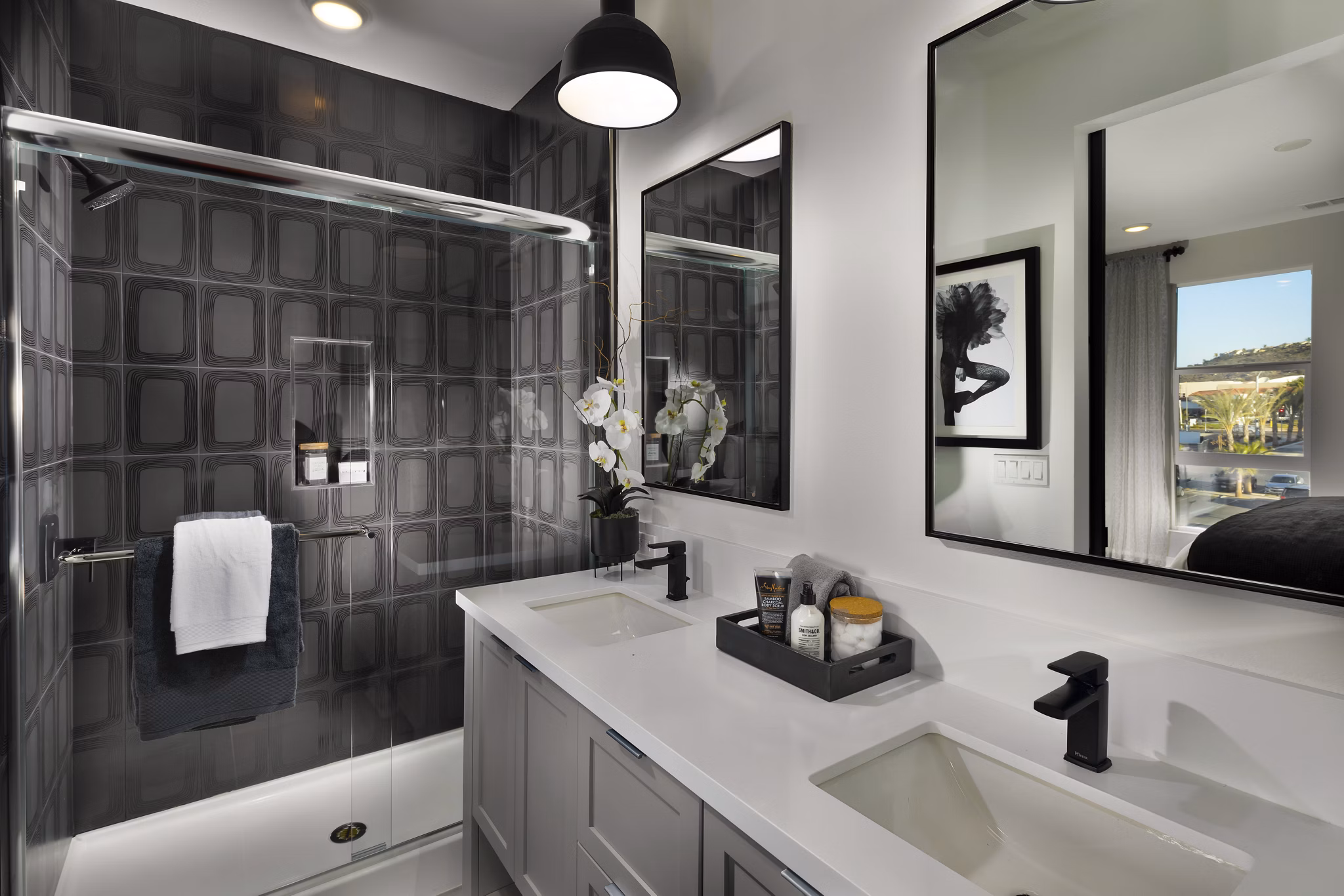 Modern bathroom with marble countertops and glass shower in Anden luxury apartments