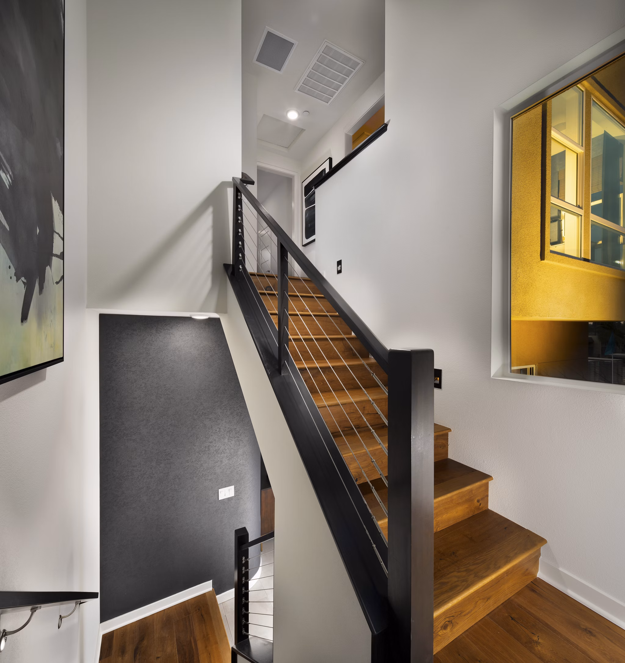 Modern hallway with sleek lighting and art at Anden luxury apartments