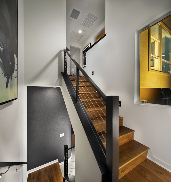 Modern hallway with sleek lighting and art at Anden luxury apartments