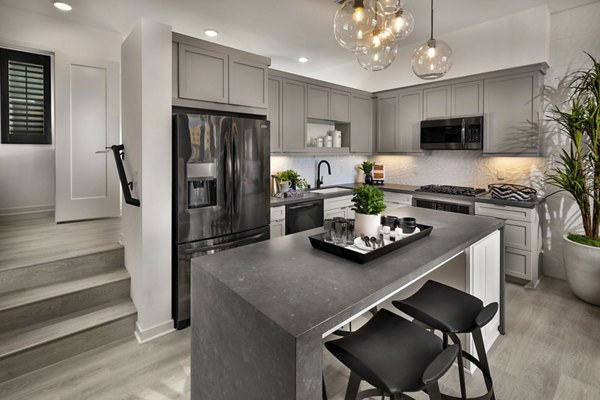 Modern kitchen with stainless steel appliances and quartz countertops at Anden luxury apartments