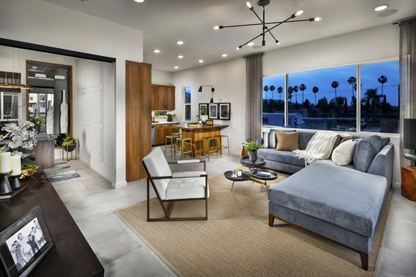 Spacious living room with modern decor and natural light at Anden luxury apartments