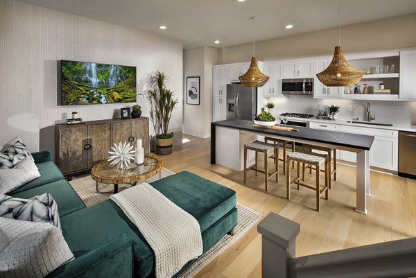 Elegant living room with stylish decor and ample natural light at Anden luxury apartments