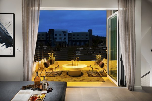 Spacious patio with modern furniture at Anden luxury apartments, ideal for outdoor relaxation and social gatherings