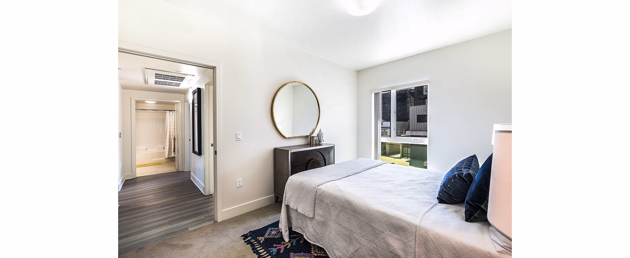 Bedroom with modern furnishings and natural light at CC Tan Center Apartments