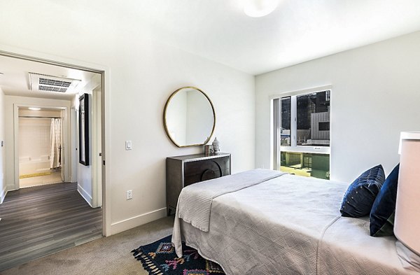 Bedroom with modern furnishings and natural light at CC Tan Center Apartments
