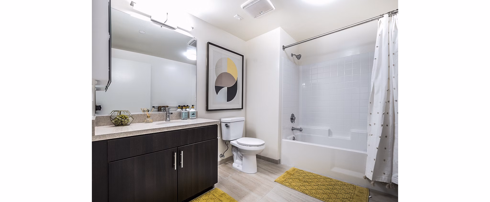 Bathroom with sleek fixtures and granite countertops at CC Tan Center Apartments