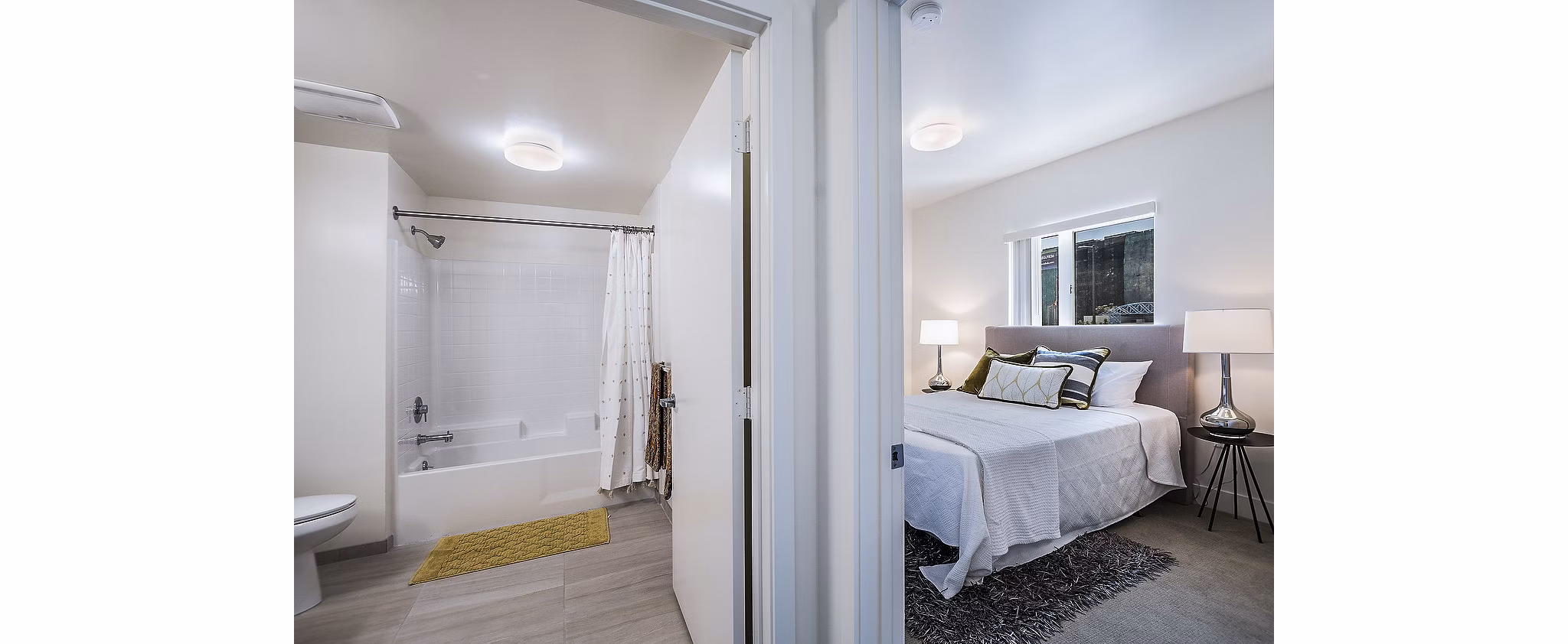 Elegant bedroom with large windows at CC Tan Center Apartments, a Greystar luxury property