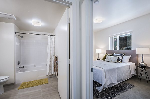 Elegant bedroom with large windows at CC Tan Center Apartments, a Greystar luxury property