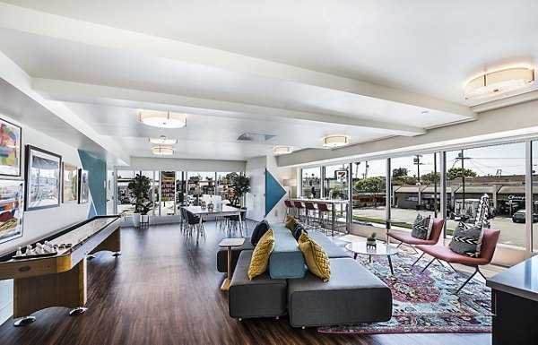 Game room with pool table and arcade games at CC Tan Center Apartments