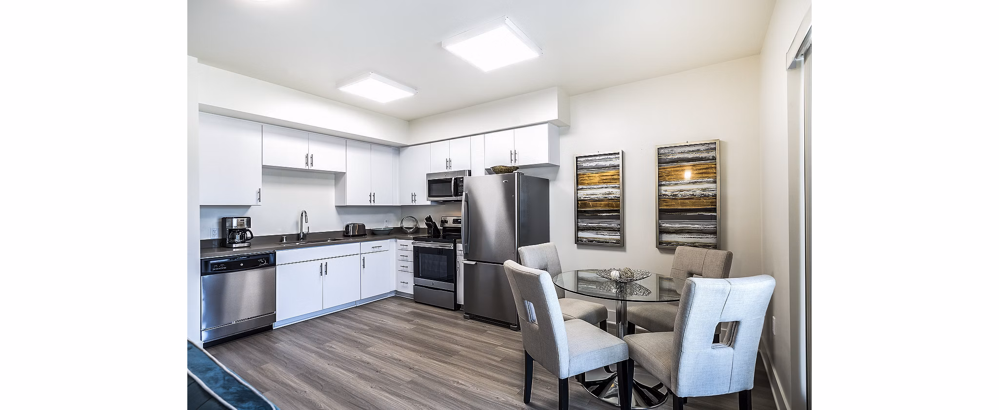 Dining room with modern decor and hardwood flooring in CC Tan Center Apartments