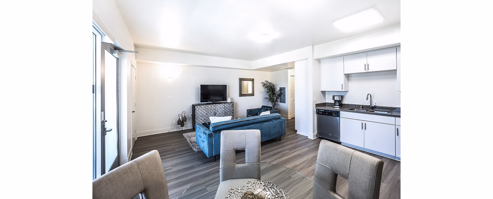 Elegant dining room with modern lighting and seating at CC Tan Center Apartments, offering luxury living spaces in the city