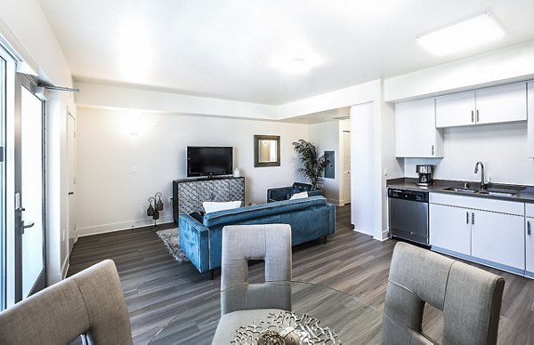 Elegant dining room with modern lighting and seating at CC Tan Center Apartments, offering luxury living spaces in the city