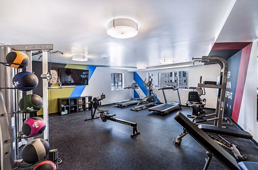 Fitness center equipped with modern machines at CC Tan Center Apartments