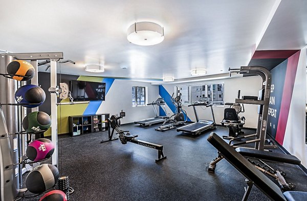 Fitness center equipped with modern machines at CC Tan Center Apartments