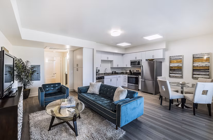 Modern living room with sleek furniture and large windows at CC Tan Center Apartments