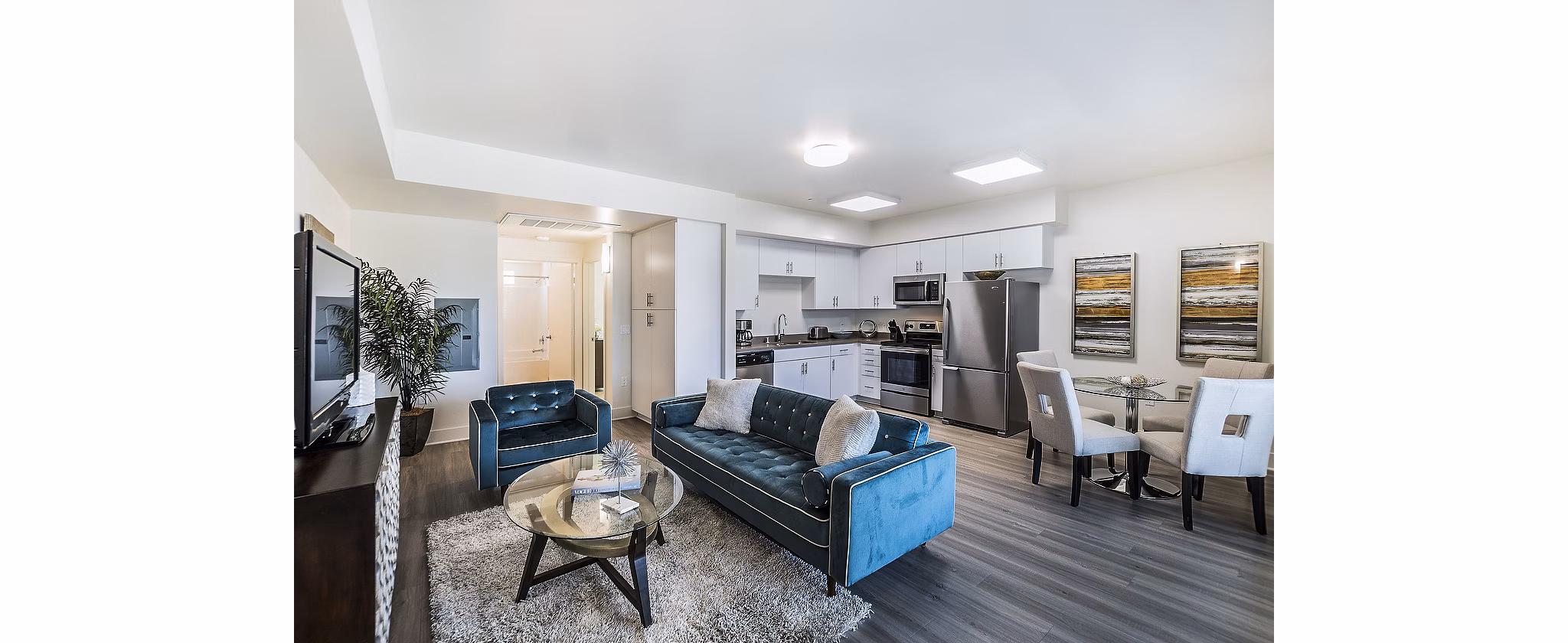 Modern living room with sleek furniture and large windows at CC Tan Center Apartments