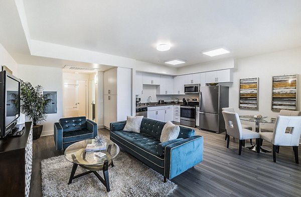 Modern living room with sleek furniture and large windows at CC Tan Center Apartments