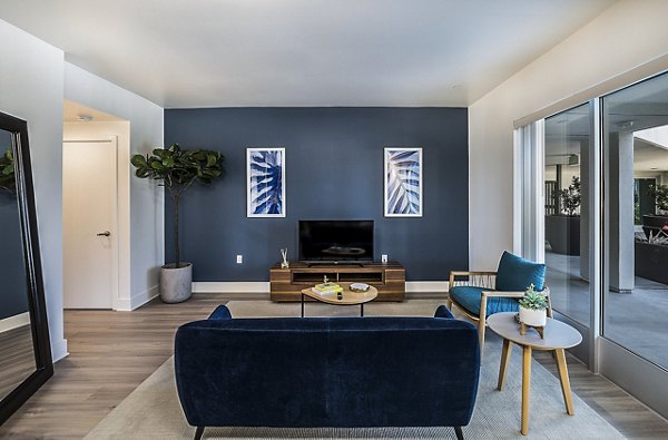 Elegant living room with plush sofas and modern decor in CC Tan Center Apartments, showcasing a luxury lifestyle in a top property
