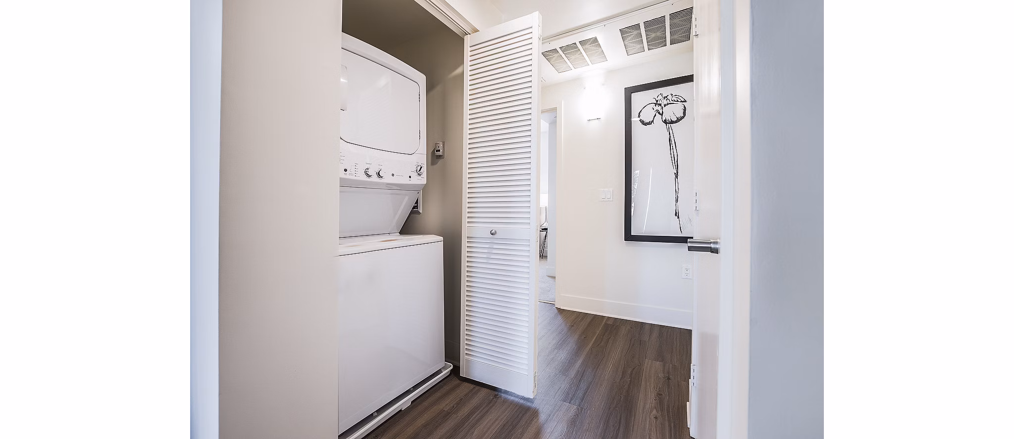 Laundry room with modern machines at CC Tan Center Apartments
