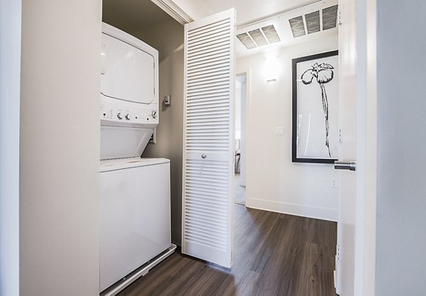 Laundry room with modern machines at CC Tan Center Apartments