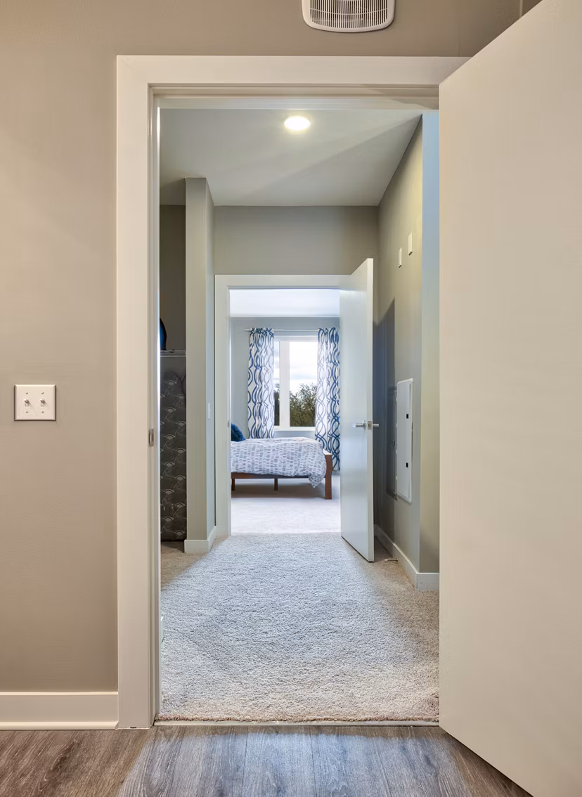 Hallway with modern lighting and decor at Ridge at Robinson Apartments