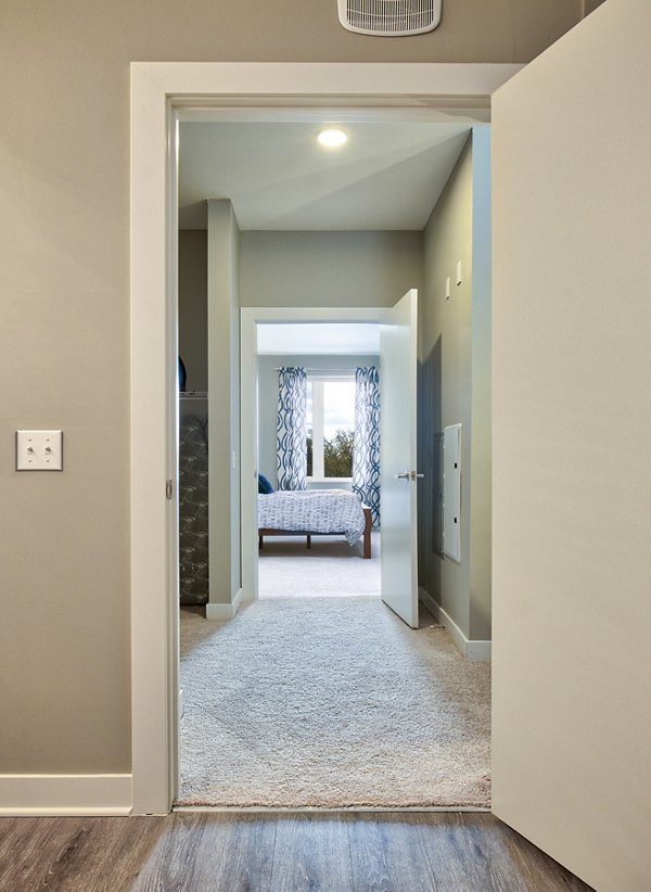 Hallway with modern lighting and decor at Ridge at Robinson Apartments