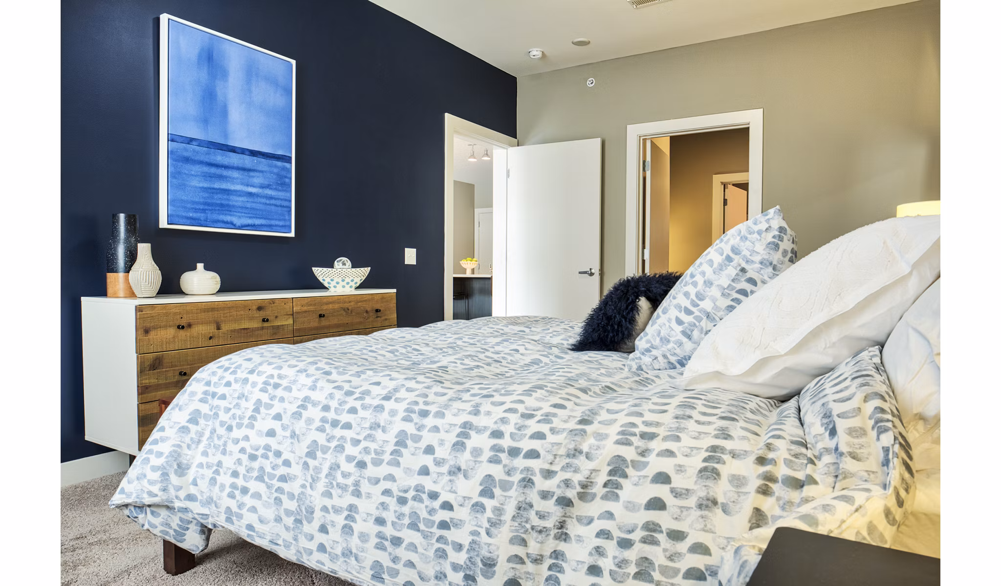 Spacious bedroom with modern furnishings in Ridge at Robinson Apartments, luxury living by Greystar