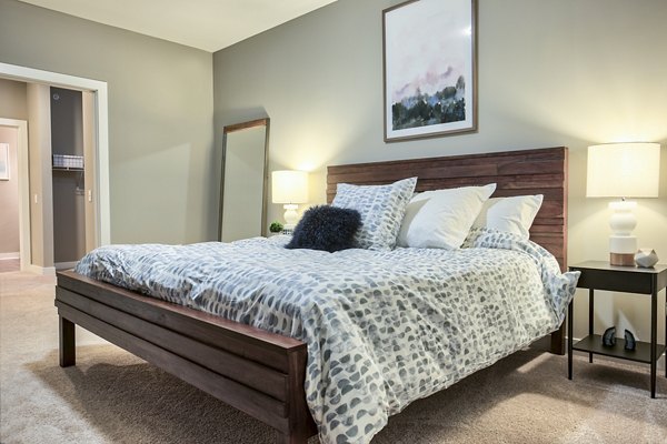 Modern bedroom with sleek furnishings at Ridge at Robinson Apartments