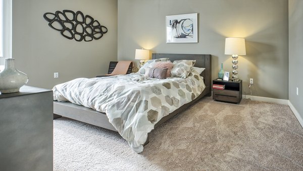 Cozy bedroom with modern furnishings at Ridge at Robinson Apartments