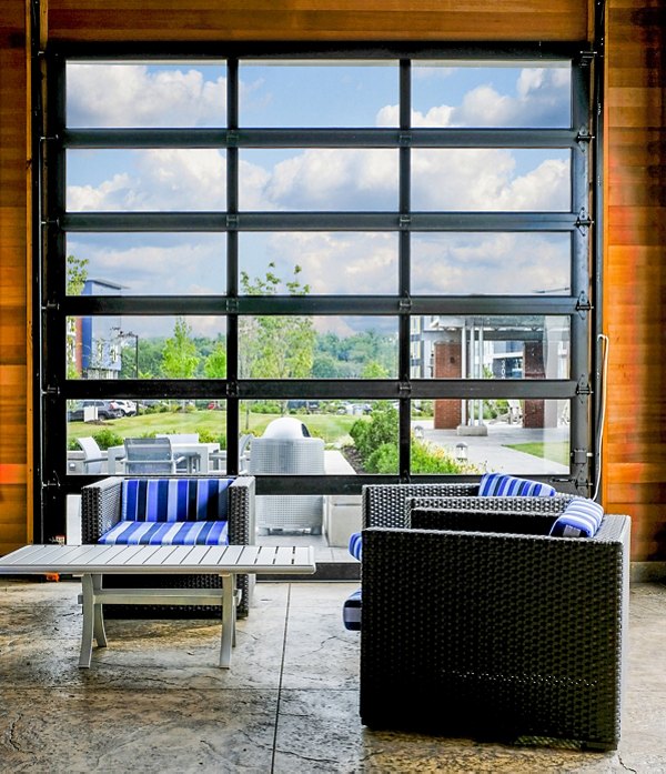 Clubhouse with modern dÃ©cor at Ridge at Robinson Apartments, featuring lounge seating and billiards for resident entertainment
