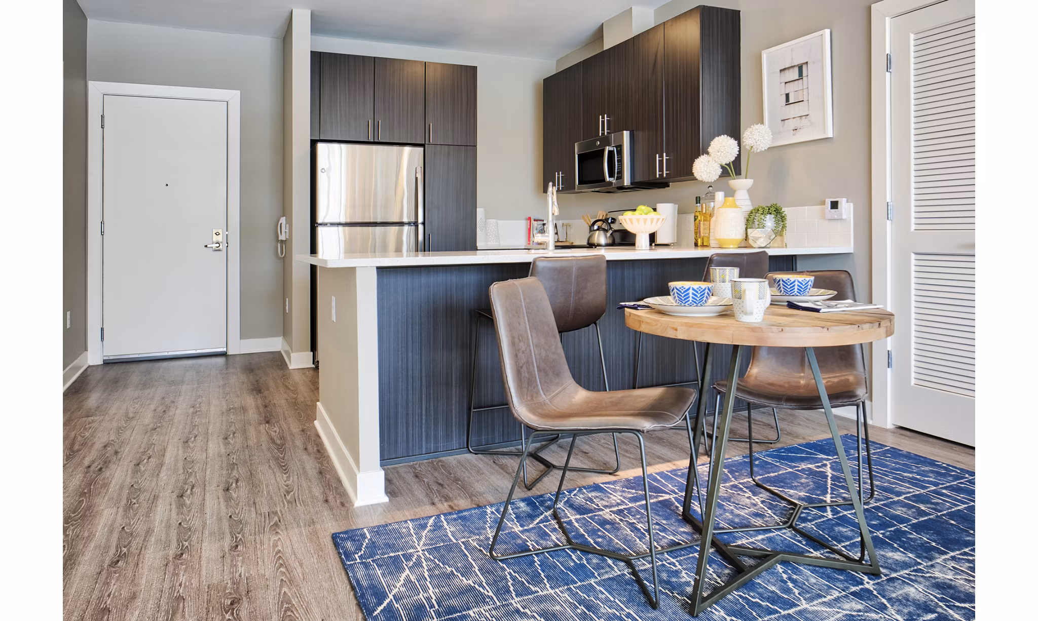Dining room with elegant chandelier at Ridge at Robinson Apartments offering luxury living in a Greystar community