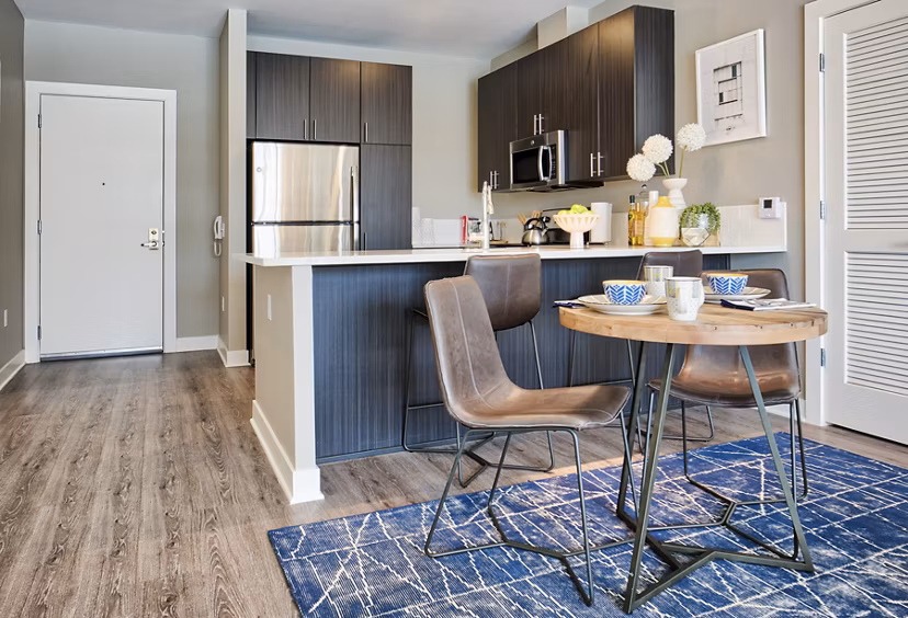 Dining room with elegant chandelier at Ridge at Robinson Apartments offering luxury living in a Greystar community