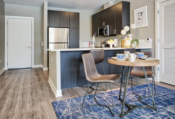 Dining room with elegant chandelier at Ridge at Robinson Apartments offering luxury living in a Greystar community