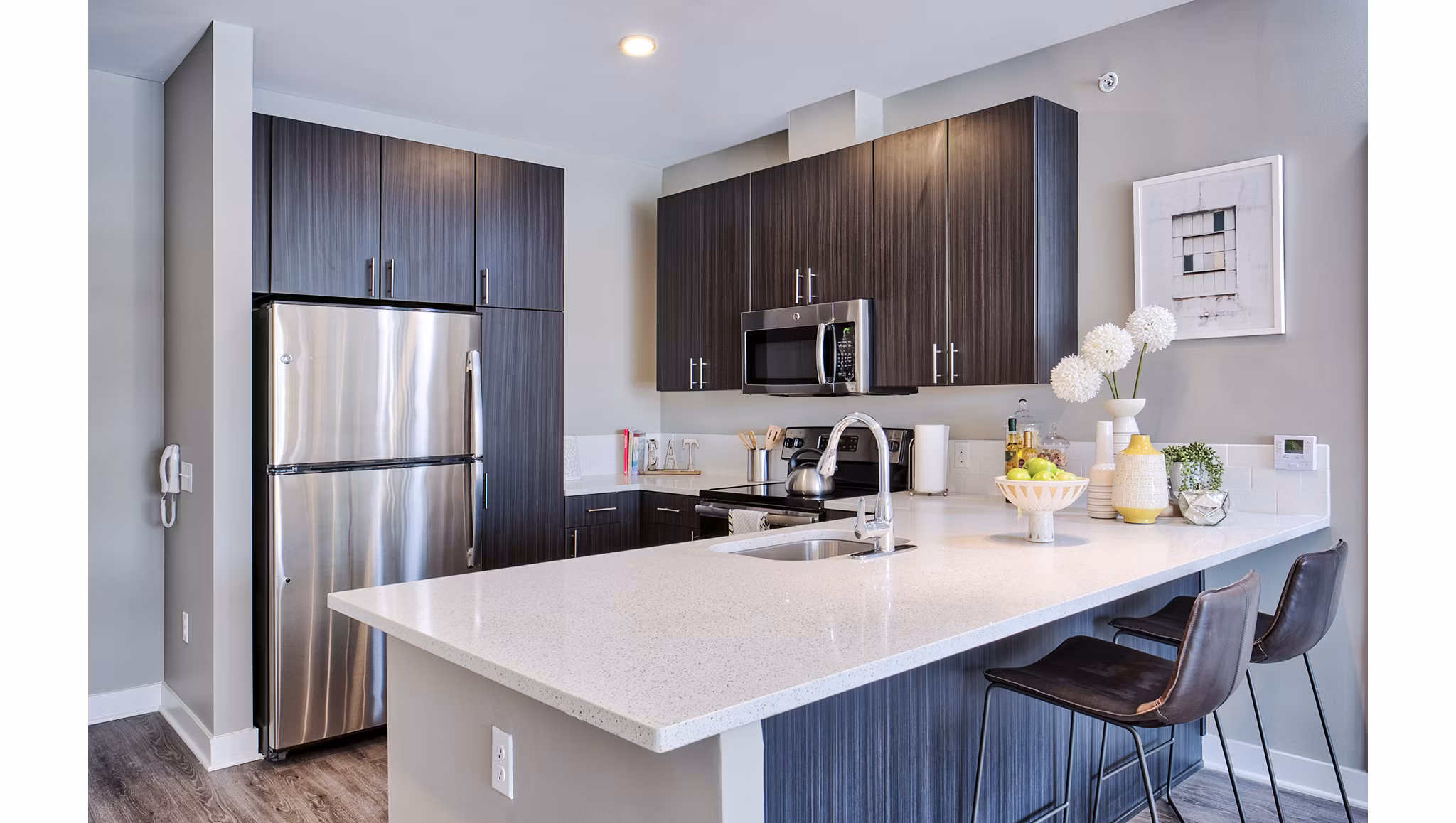 Modern kitchen with sleek appliances in Ridge at Robinson Apartments, luxury living by Greystar