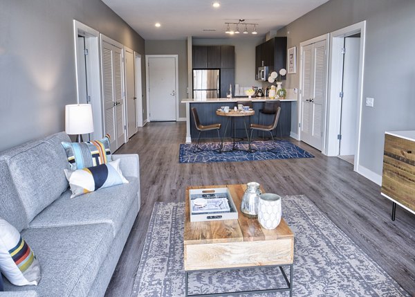 Inviting living room with cozy seating and bright decor in Ridge at Robinson Apartments
