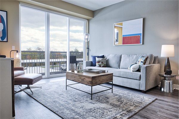 Modern living room with sleek furnishings and natural light at Ridge at Robinson Apartments