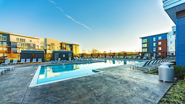 Outdoor pool with sundeck and lounge chairs at Ridge at Robinson Apartments, perfect for relaxation and leisure activities